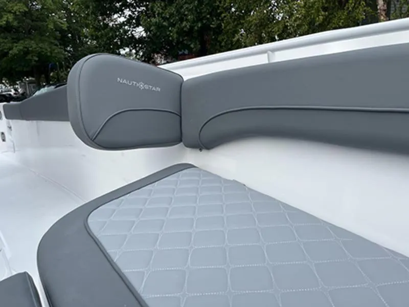 Slide: The Image of 2025 NauticStar 292 Legacy boat interior with gray cushioned seating. - 6