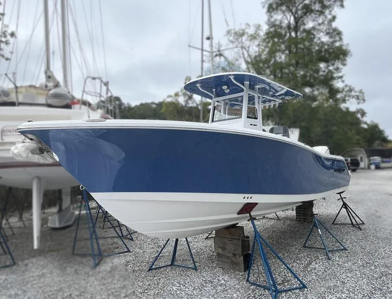 Slide: The Image of 2025 NauticStar 292 Legacy boat in dry dock, blue and white hull. - 8