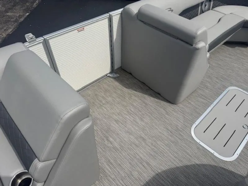 Slide: The Image of 2025 Bennington L Bowrider Swingback 25 LTSB interior with gray seating and carpeted floor. - 10