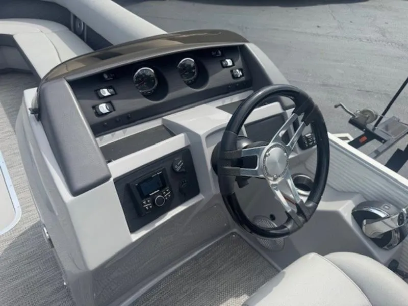 Slide: The Image of 2025 Bennington L Bowrider Swingback 25 LTSB dashboard with steering wheel and controls. - 17