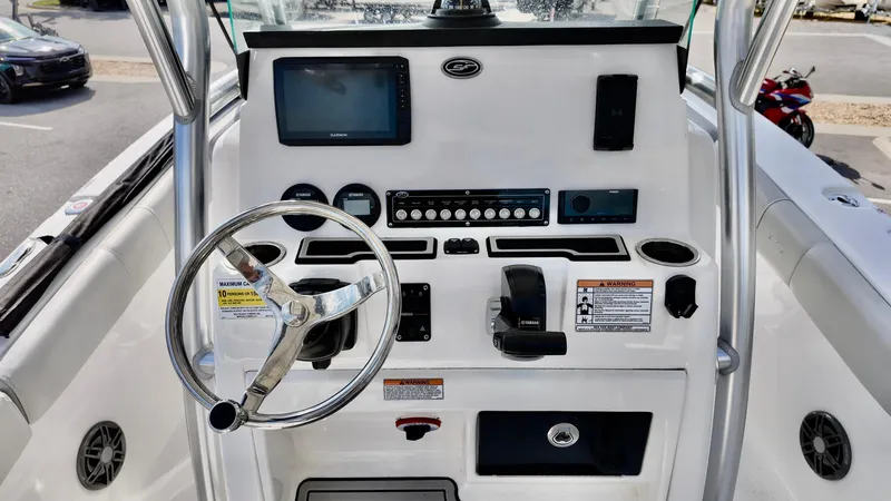 Slide: The Image of 2023 Sea Fox 248 Commander boat dashboard with steering wheel and navigation controls. - 11