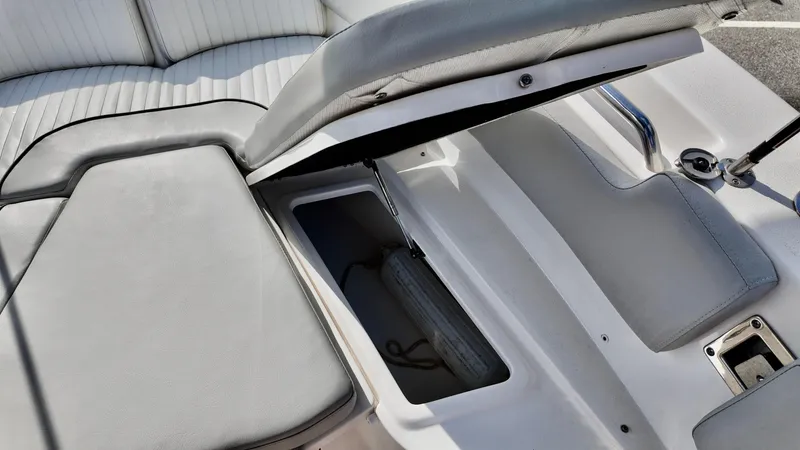 Slide: The Image of 2023 Sea Fox 248 Commander boat seat storage compartment open, revealing interior space. - 13
