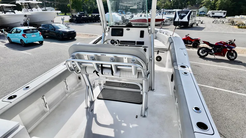 Slide: The Image of 2023 Sea Fox 248 Commander boat interior with helm and seating in a parking lot. - 18