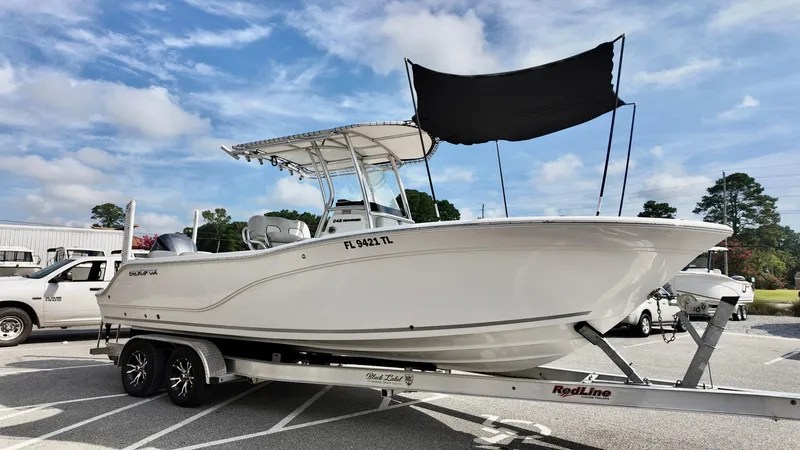 Slide: The Image of 2023 Sea Fox 248 Commander boat on trailer under blue sky. - 3
