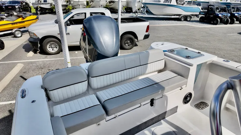 Slide: The Image of 2023 Sea Fox 248 Commander boat interior with seating and motor in a parking lot. - 9