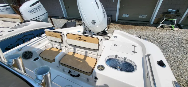 Slide: The Image of 2023 Sea Chaser 23 LX boat interior with Suzuki engines and seating area. - 13