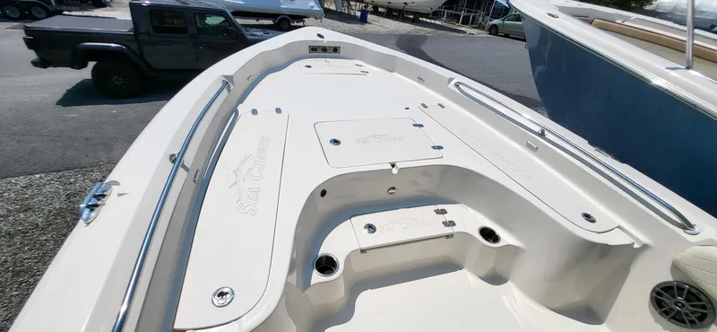 Slide: The Image of 2023 Sea Chaser 23 LX boat deck with storage compartments and sleek design. - 17