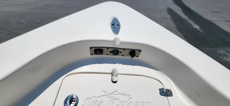 Slide: The Image of 2023 Sea Chaser 23 LX boat deck with storage compartment and logo. - 3