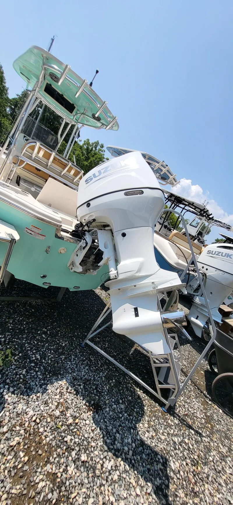 Slide: The Image of 2023 Sea Chaser 23 LX boat with Suzuki outboard motor on gravel. - 5