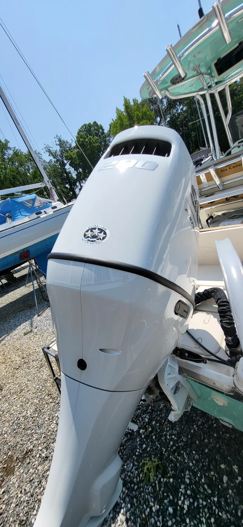 Slide: The Image of 2023 Sea Chaser 23 LX boat engine, parked outdoors on gravel. - 6