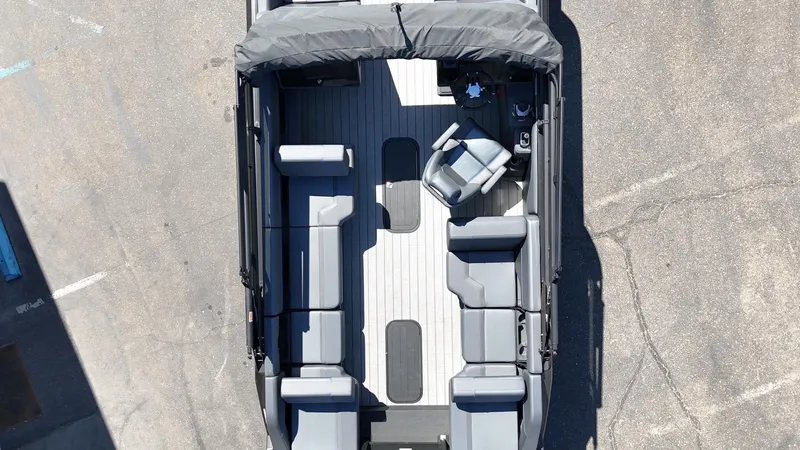 Slide: The Image of Overhead view of 2025 Manitou Explore Dual Engine boat interior with seating and helm. - 12