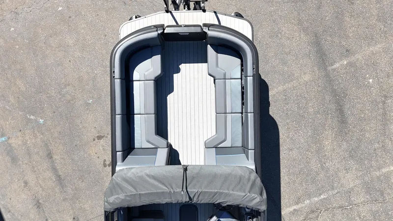 Slide: The Image of 2025 Manitou Explore Dual Engine boat, aerial view, showcasing spacious seating and sleek design. - 13