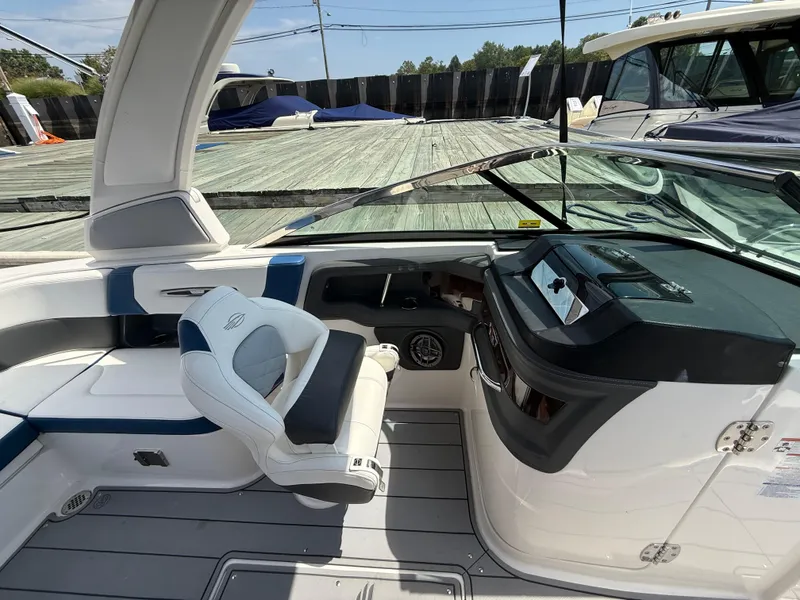 Slide: The Image of 2022 Chaparral 267 SSX OB boat interior with helm and seating area. - 18