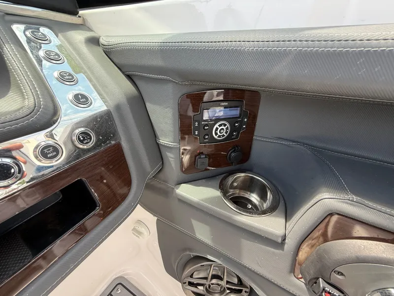 Slide: The Image of 2022 Chaparral 267 SSX OB dashboard with control panel and cup holder. - 21