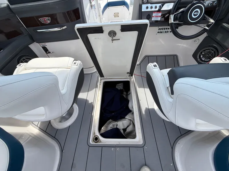 Slide: The Image of 2022 Chaparral 267 SSX OB boat interior with open storage compartment. - 22