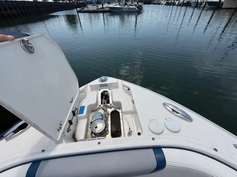 Slide: The Image of Open anchor compartment on 2022 Chaparral 267 SSX OB boat at marina. - 27