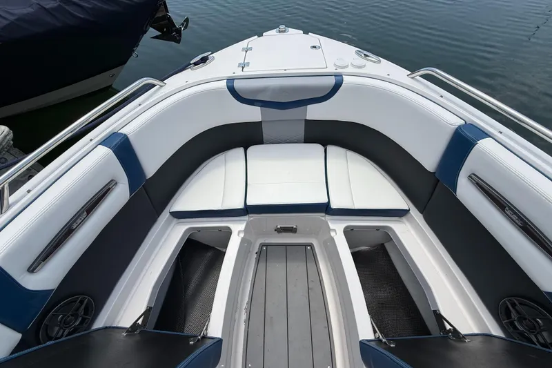 Slide: The Image of 2022 Chaparral 267 SSX OB boat interior with cushioned seating and storage compartments. - 28