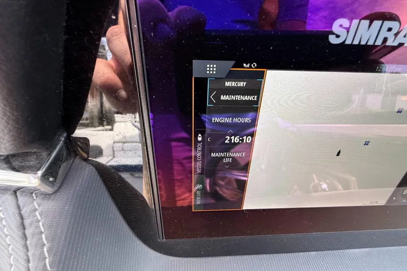 Slide: The Image of Display screen of 2022 Chaparral 267 SSX OB showing engine hours and maintenance details. - 30