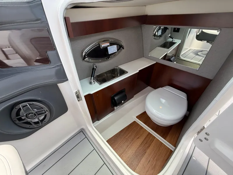 Slide: The Image of 2022 Chaparral 267 SSX OB boat interior with sink, toilet, and mirror. - 31