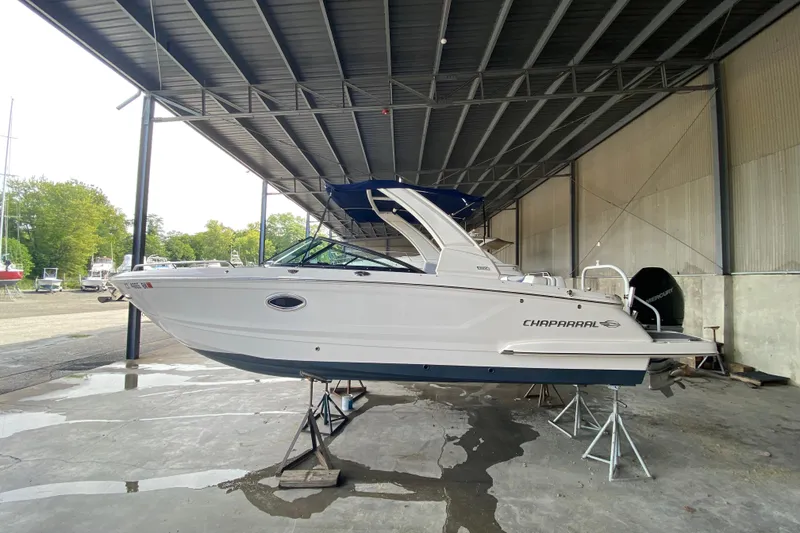 Slide: The Image of 2022 Chaparral 267 SSX OB boat in covered storage, side view. - 34