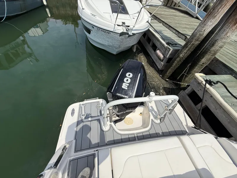 Slide: The Image of 2022 Chaparral 267 SSX OB boat with Mercury outboard engine docked at marina. - 5