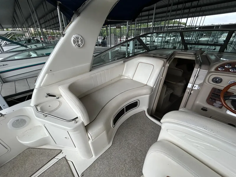 Slide: The Image of Interior of a 2000 Sea Ray 290 Sundancer boat with seating and control panel. - 3
