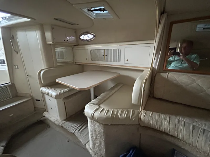 Slide: The Image of Interior of 2000 Sea Ray 290 Sundancer with dining area and seating. - 9