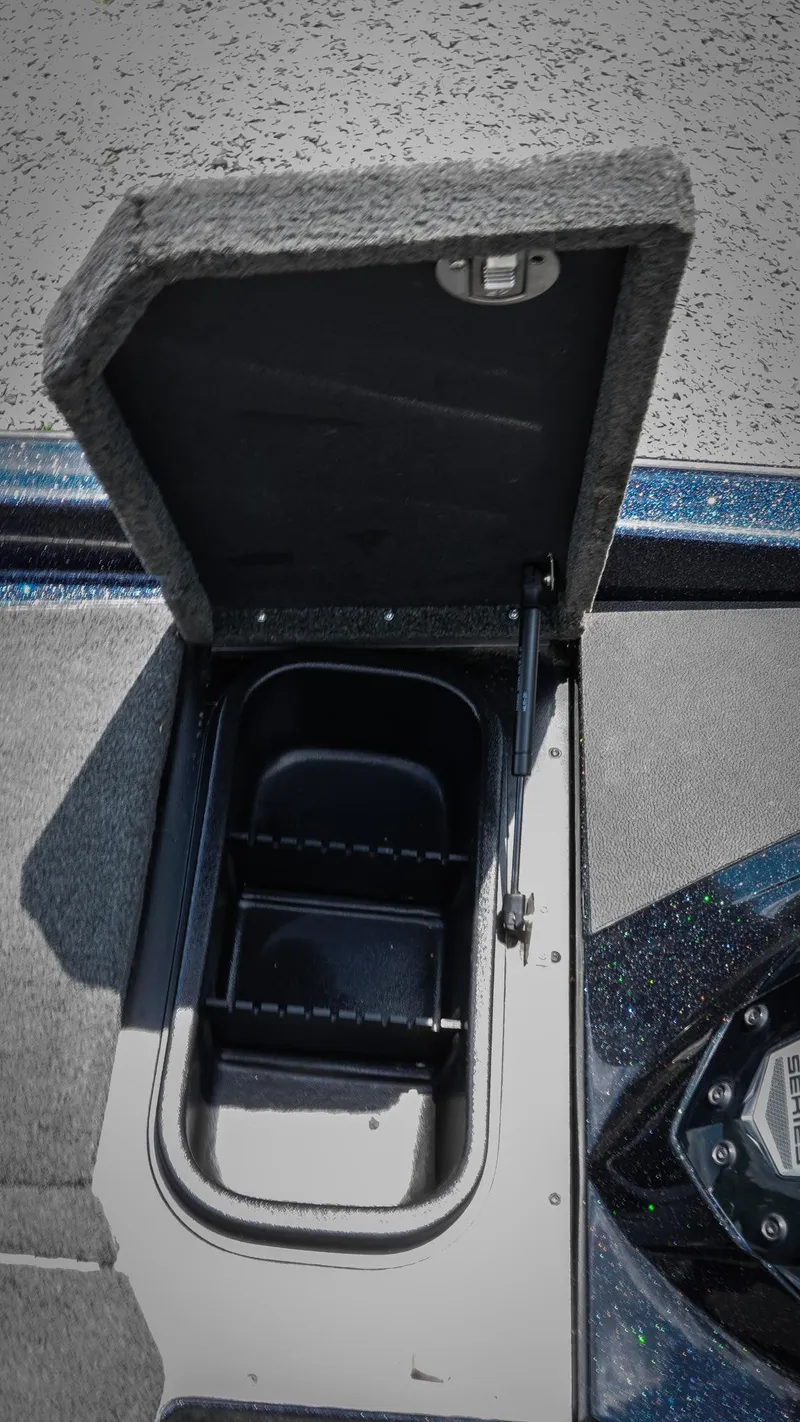 Slide: The Image of 2020 Skeeter ZX225 boat storage compartment with open lid, showcasing interior space. - 16