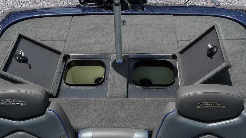 Slide: The Image of 2020 Skeeter ZX225 boat interior with open storage compartments and cushioned seats. - 17