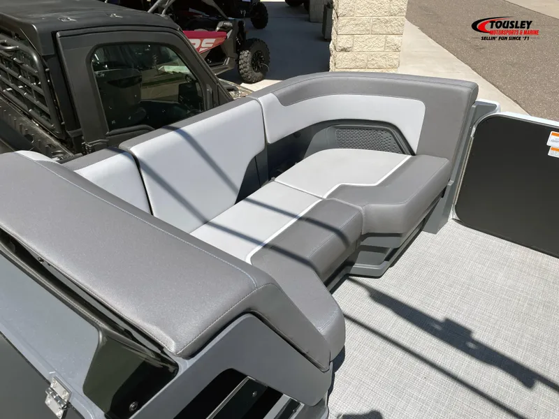 Slide: The Image of 2025 Manitou Cruise 22 Switchback Twin Tube boat interior with gray seating. - 10