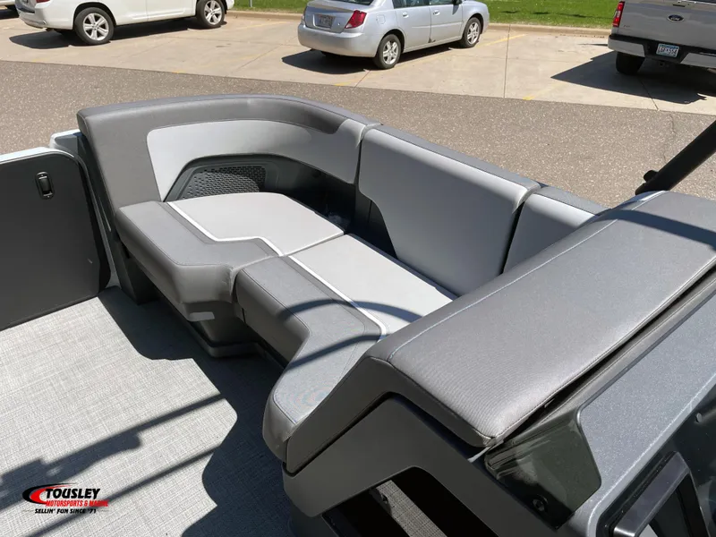 Slide: The Image of 2025 Manitou Cruise 22 Switchback Twin Tube boat interior with gray seating. - 11