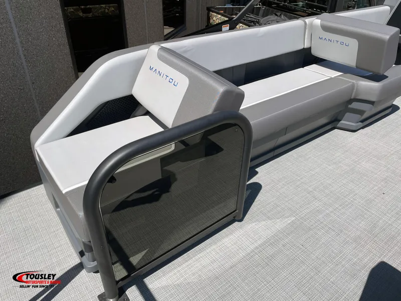 Slide: The Image of 2025 Manitou Cruise 22 Switchback Twin Tube boat seating area with modern design and branding. - 5