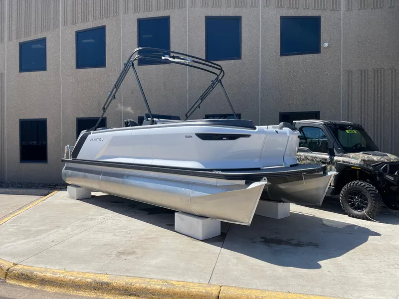 Slide: The Image of 2025 Manitou Cruise 22 Switchback Twin Tube pontoon boat displayed outdoors. - 9