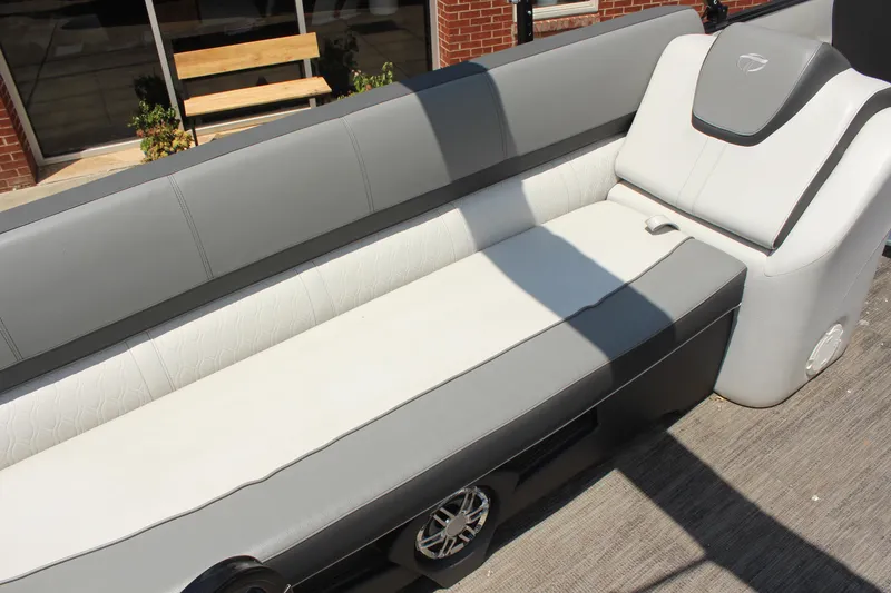 Slide: The Image of 2023 Tahoe CASCADE boat interior with gray and white seating, outdoor setting. - 13