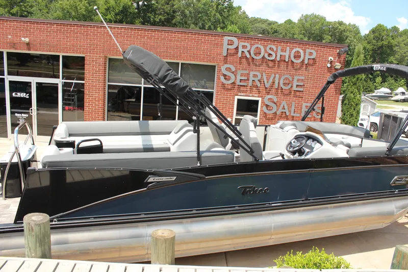 Slide: The Image of 2023 Tahoe CASCADE pontoon boat at a pro shop with service and sales signage. - 5