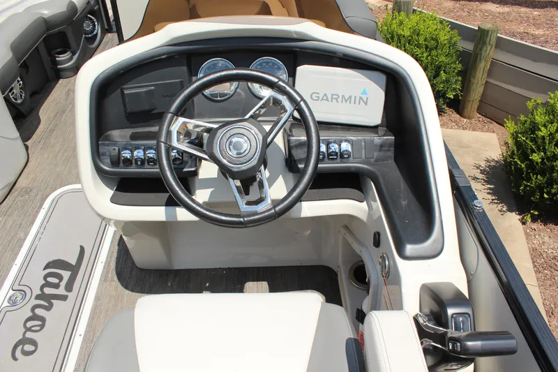 Slide: The Image of 2023 Tahoe CASCADE boat dashboard with steering wheel and Garmin navigation system. - 7
