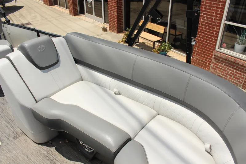 Slide: The Image of 2023 Tahoe CASCADE boat interior with gray and white seating, outdoor setting. - 8