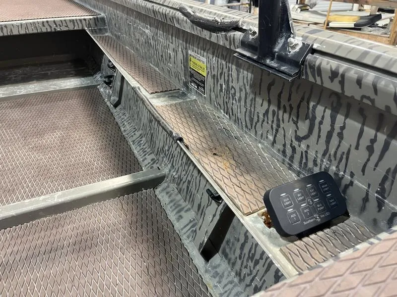 Slide: The Image of 2025 Gator Tail 1750 Savage Mid Deck interior with control panel and textured flooring. - 10