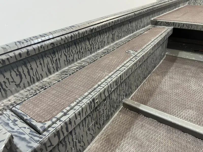 Slide: The Image of 2025 Gator Tail 1750 Savage Mid Deck boat interior with textured flooring and camo design. - 9