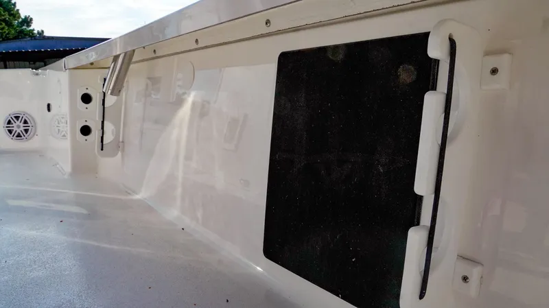 Slide: The Image of 2026 Tidewater 2410 Bay Max boat interior with speakers and storage compartments. - 23