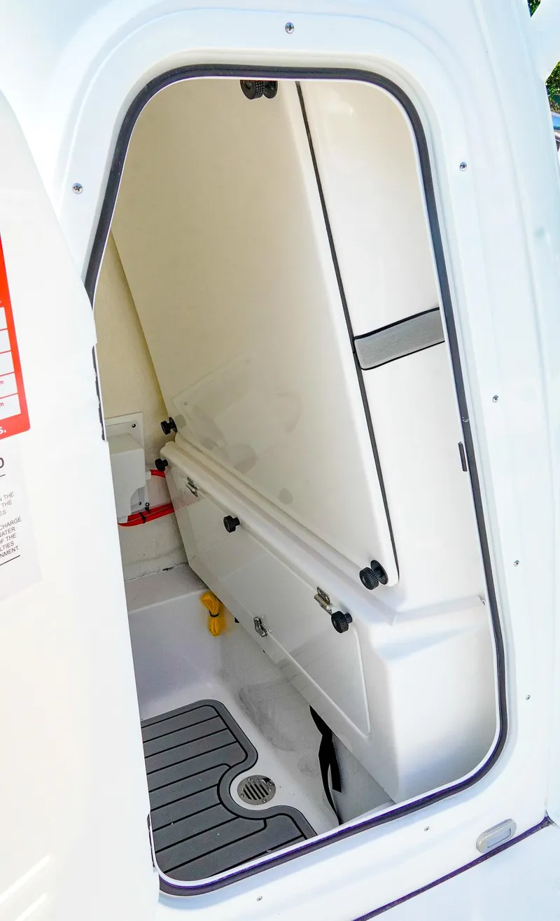 Slide: The Image of 2026 Tidewater 2410 Bay Max boat interior, featuring a compact storage compartment with a non-slip floor. - 27