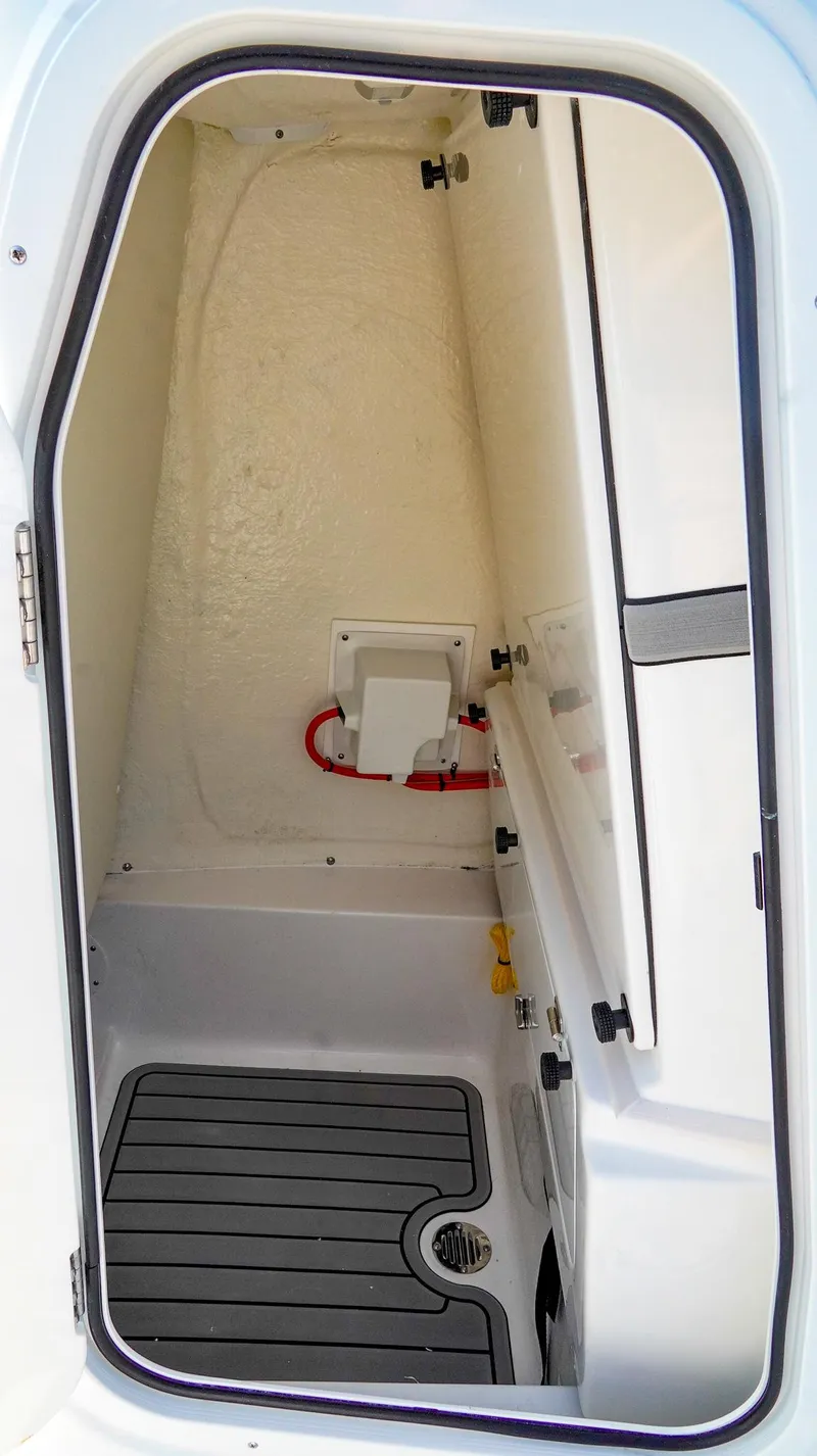 Slide: The Image of 2026 Tidewater 2410 Bay Max boat interior storage compartment with non-slip flooring. - 28