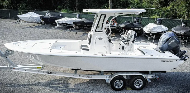 Slide: The Image of 2026 Tidewater 2410 Bay Max boat on trailer, side view, in a parking lot. - 3