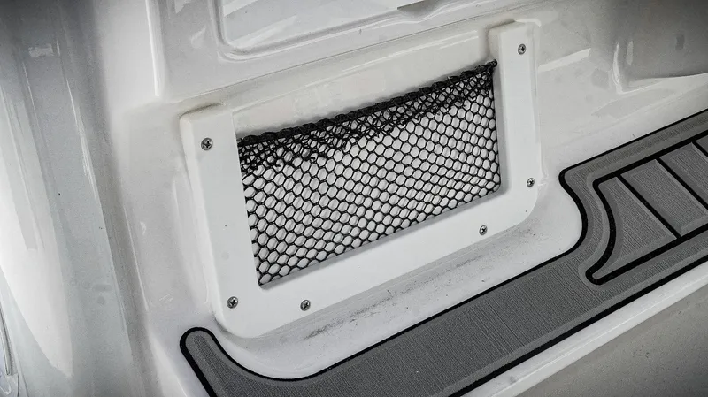 Slide: The Image of 2026 Tidewater 2410 Bay Max boat storage compartment with netting and non-slip flooring. - 31