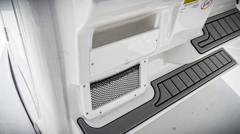 Slide: The Image of 2026 Tidewater 2410 Bay Max boat interior with storage compartment and non-slip flooring. - 32