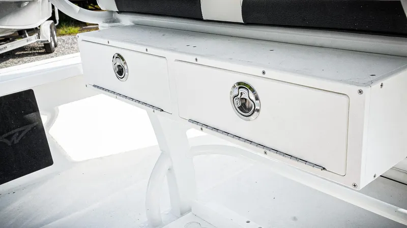 Slide: The Image of 2026 Tidewater 2410 Bay Max boat storage compartments with secure latches. - 33