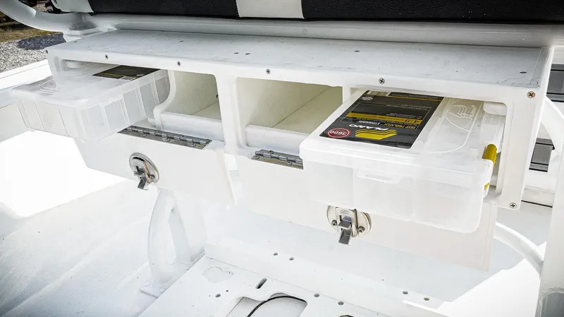 Slide: The Image of Storage compartments on a 2026 Tidewater 2410 Bay Max boat, featuring organized tackle boxes. - 34