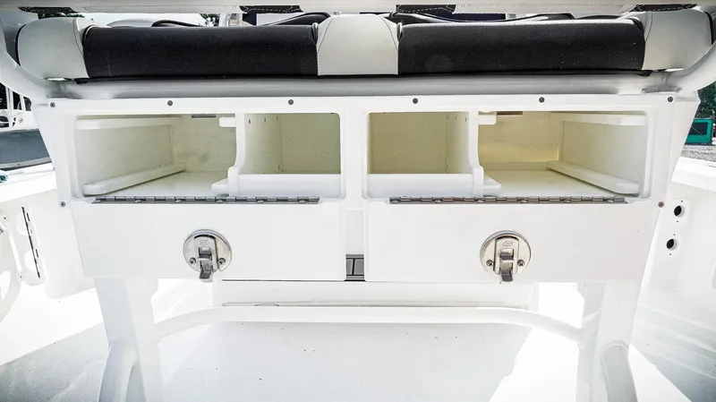 Slide: The Image of 2026 Tidewater 2410 Bay Max boat storage compartments with secure latches. - 35