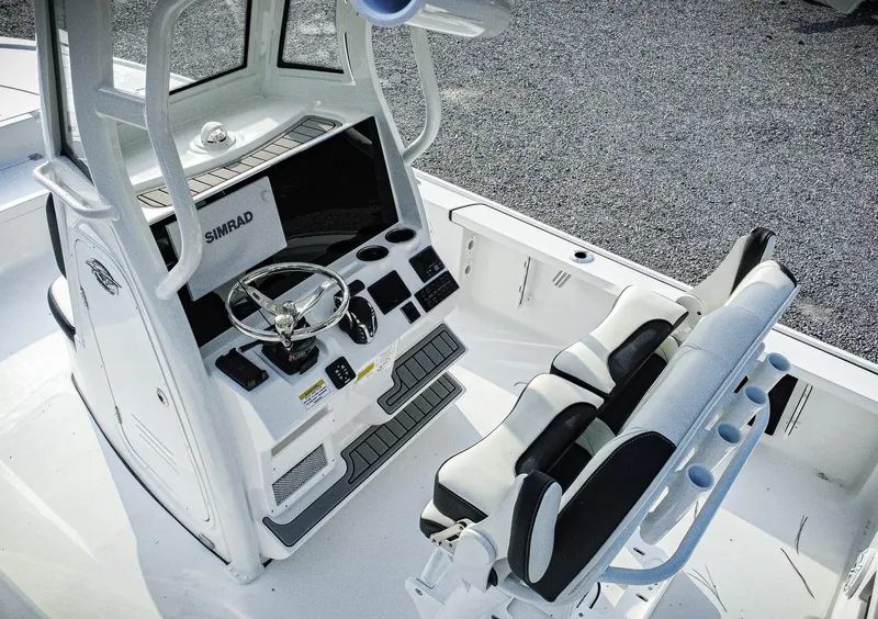Slide: The Image of 2026 Tidewater 2410 Bay Max boat cockpit with Simrad electronics and dual seating. - 47