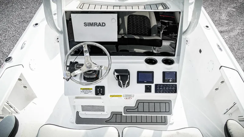 Slide: The Image of 2026 Tidewater 2410 Bay Max boat console with Simrad electronics and steering wheel. - 49